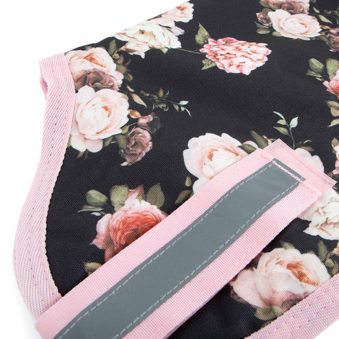 Jeffers 600D waterproof ripstop dog coat with floral black fabric, pink trim, and gray reflective strap