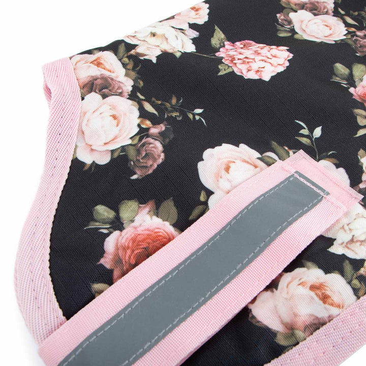 Jeffers 600D waterproof ripstop dog coat with floral black fabric, pink trim, and gray reflective strap