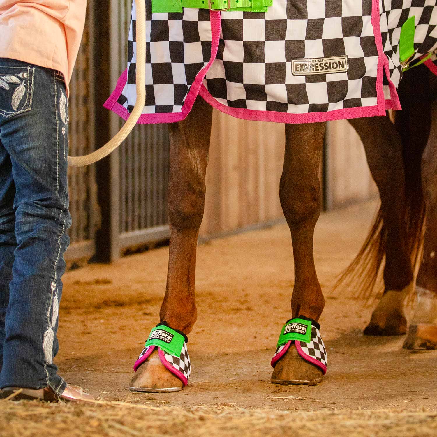 Jeffers Expression No-Turn Bell Boots for horses, nylon pair with neon green straps, pink trim, checkerboard pattern
