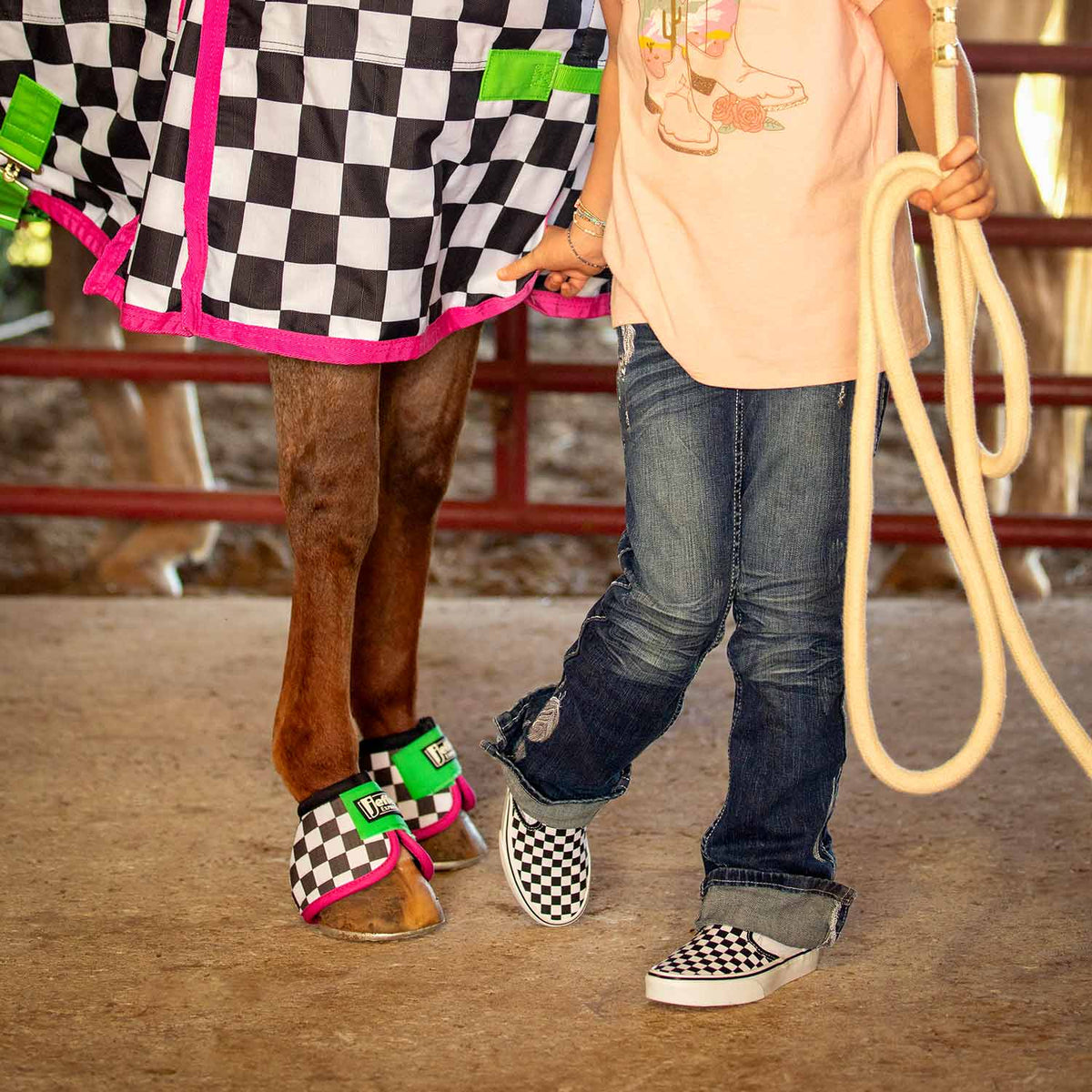 Jeffers Expression No-Turn Bell Boots for Horses, nylon pair in black-and-white checker with pink edge and green strap