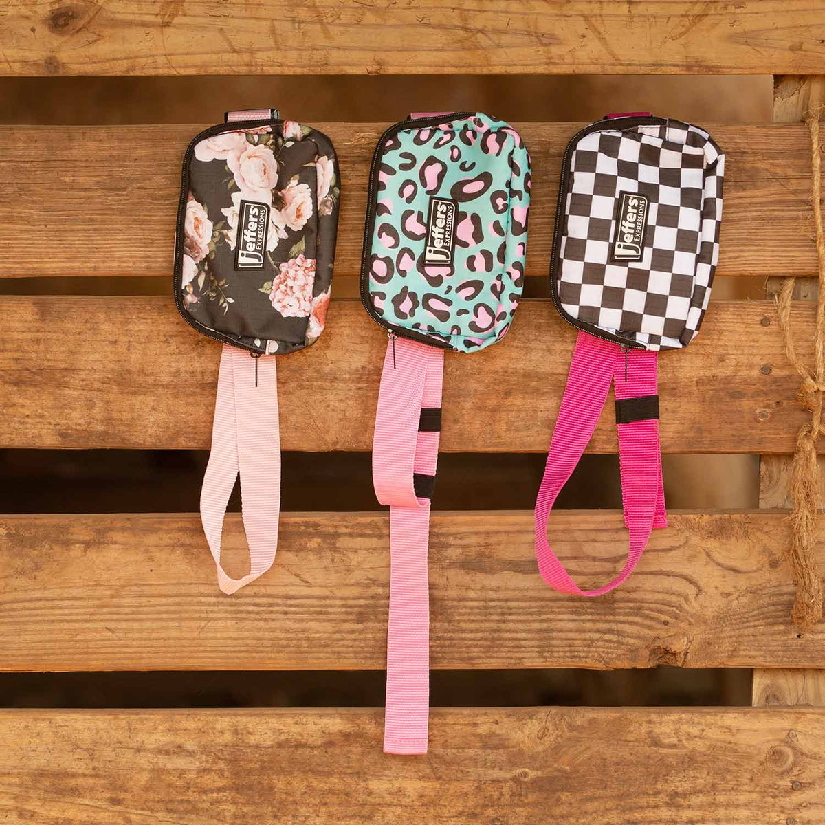 Jeffers Expression belt bag set; 3 fanny packs with floral, teal leopard, and checker patterns, pink straps.