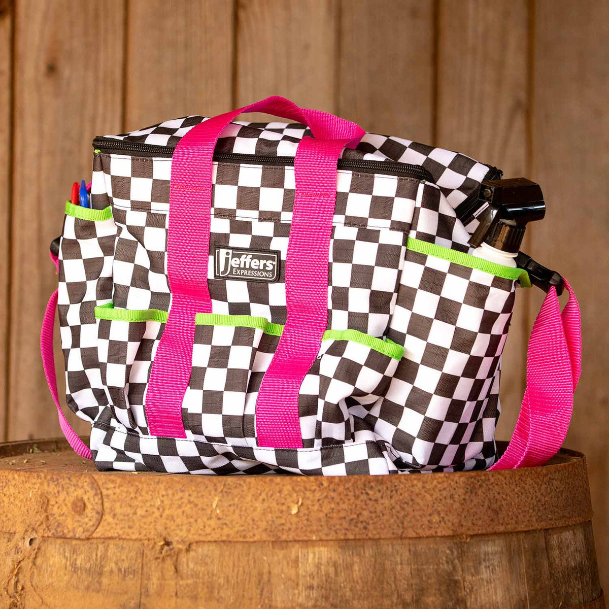 Jeffers Expressions Deluxe horse grooming bag with adjustable pink strap and neon green accents in checkerboard pattern.