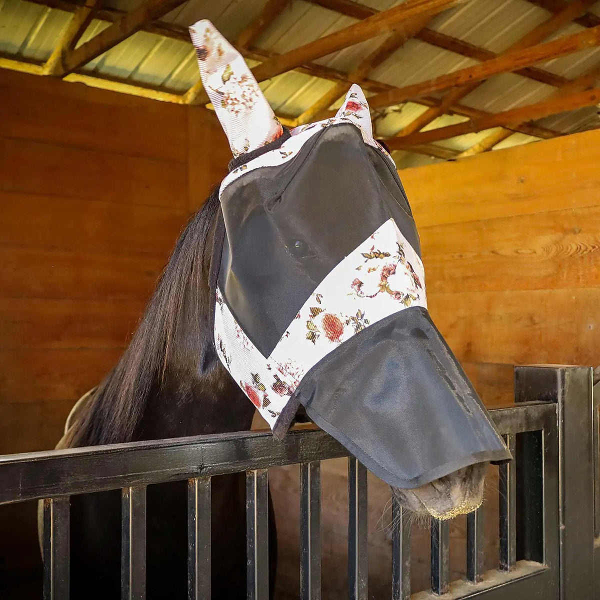 Jeffers Expression Deluxe mesh horse fly mask with ears and nose; white floral and black fabric on a horse in a stall.