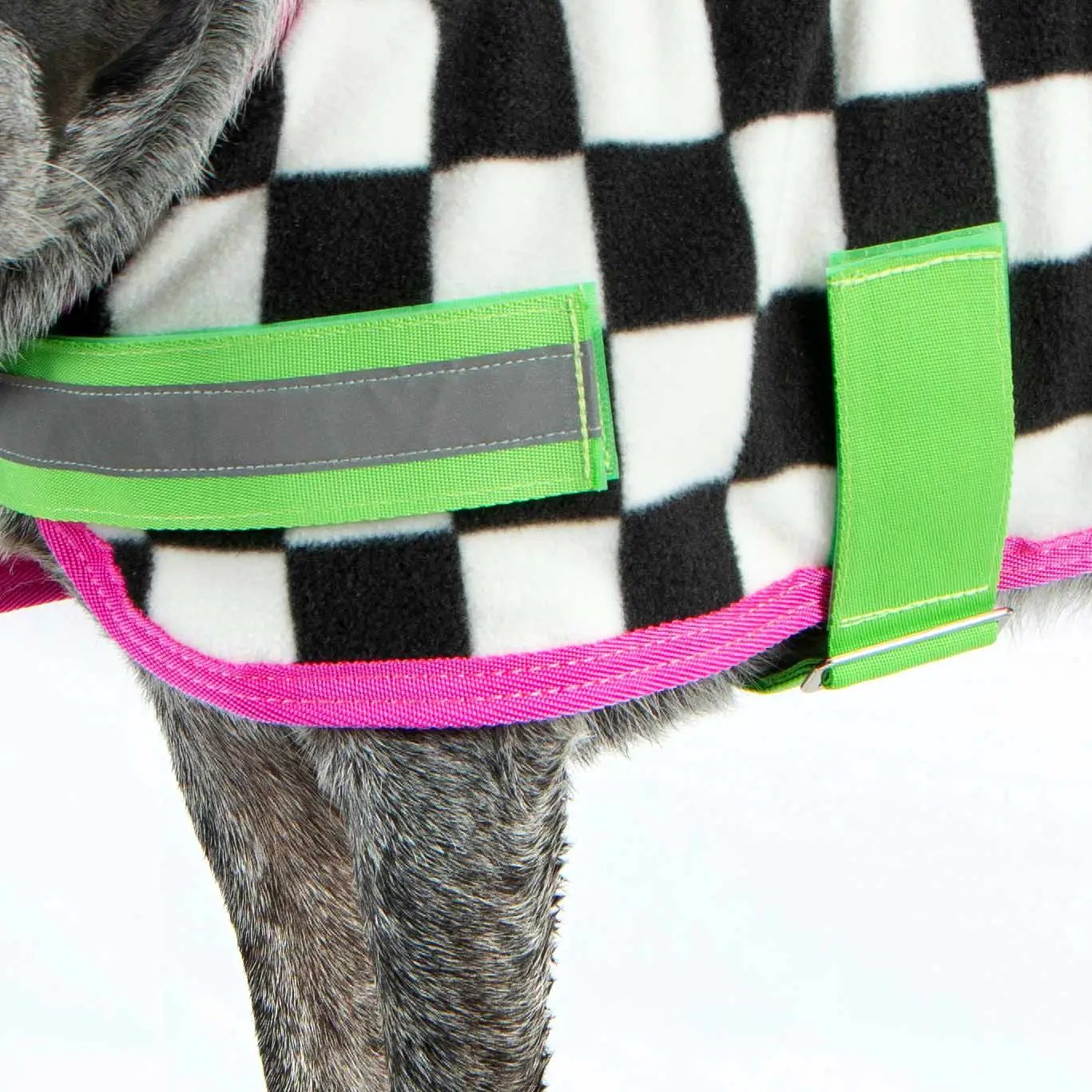 Jeffers Expression Moisture-Wicking Fleece Dog Coat with neon green straps and pink trim on black-and-white plaid.