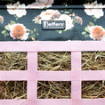 Load image into Gallery viewer, Jeffers Expression Extend-Feed Hay Bag with floral navy fabric and pink straps, hay inside
