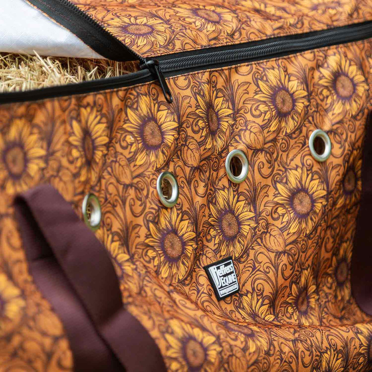 Jeffers Expression Full Hay Bale Tote Bag in orange sunflower-print fabric with metal grommets and zippered top.