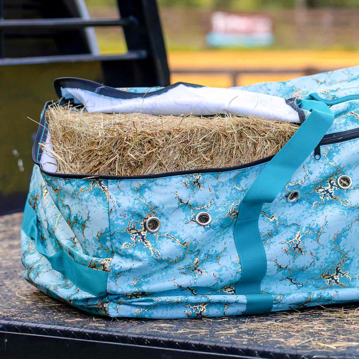 Jeffers Expression hay bale tote bag filled with hay, turquoise marbled fabric with teal strap