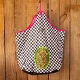 Load image into Gallery viewer, Jeffers Expression Top Loading Hay Bag, 600 Denier; black-and-white checker fabric with pink trim and green opening.
