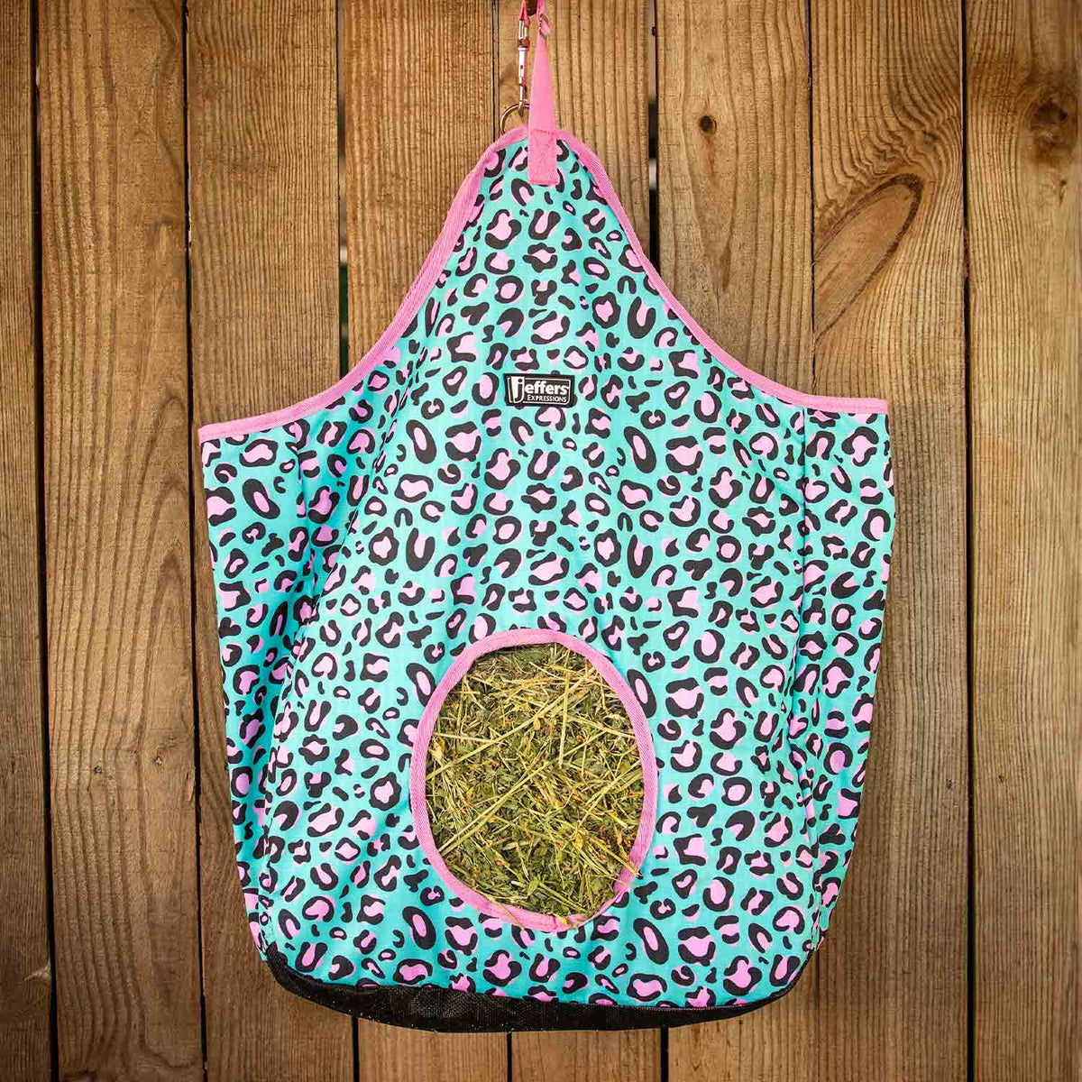 Jeffers Expressions top-loading hay bag, turquoise with pink leopard print, 600 Denier fabric.