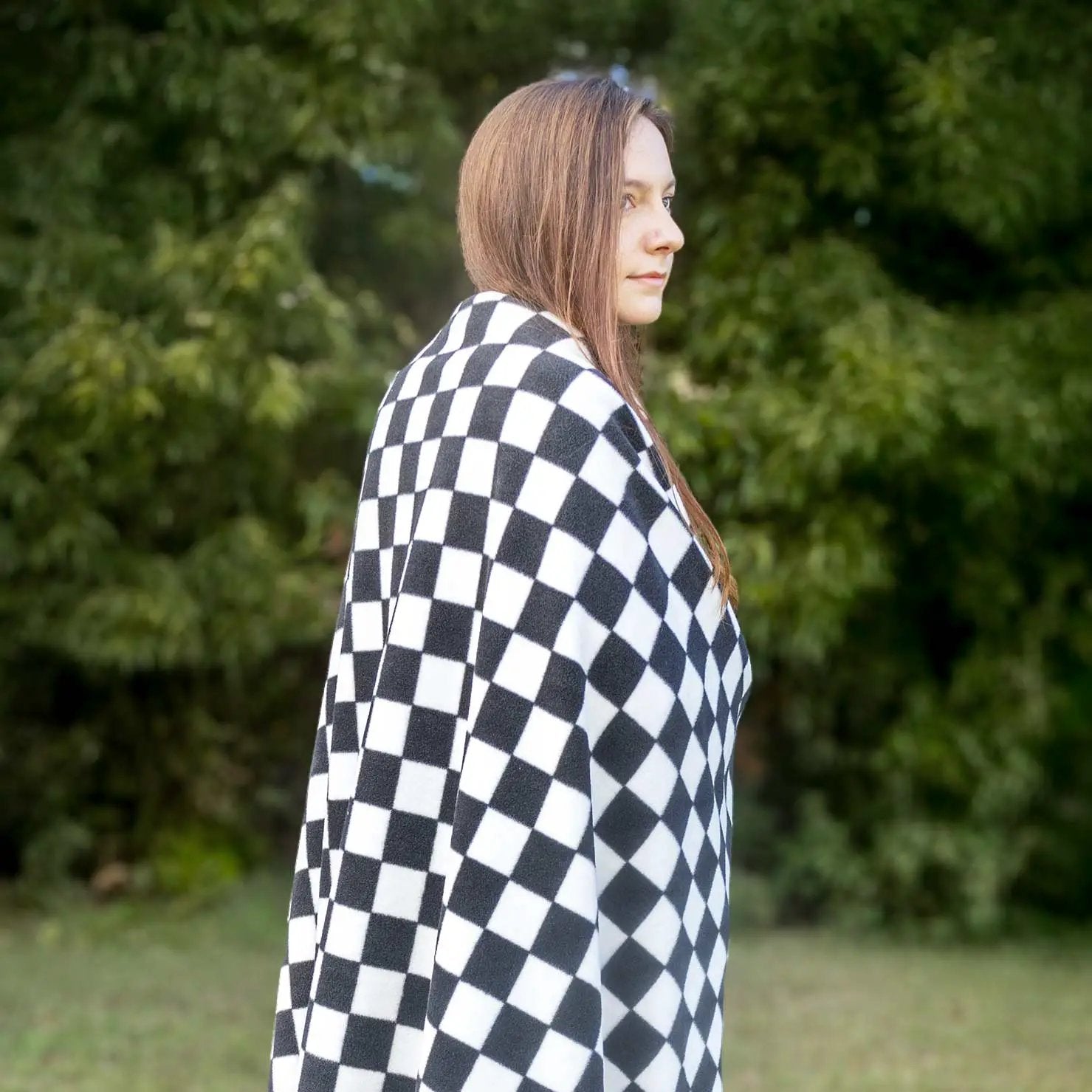 Jeffers Expression oversized fleece throw blanket in black-and-white checker pattern draped over a person