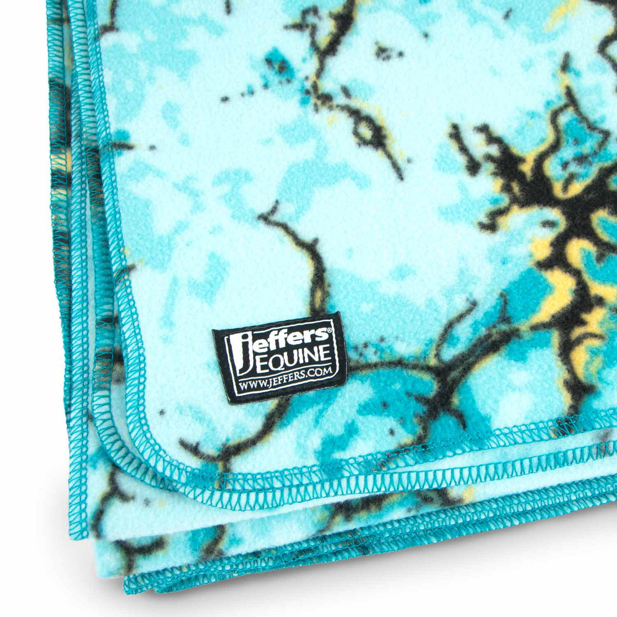 Jeffers Expression oversized fleece throw blanket in turquoise tie-dye with teal binding, brand tag visible