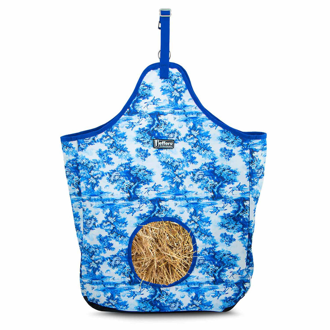 Jeffers Expressions top-loading hay bag, 600 denier, blue-and-white toile print with straw visible.
