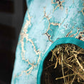 Load image into Gallery viewer, Jeffers Expression top-loading hay bag, 600 Denier, teal fabric with teal strap and visible hay spilling out
