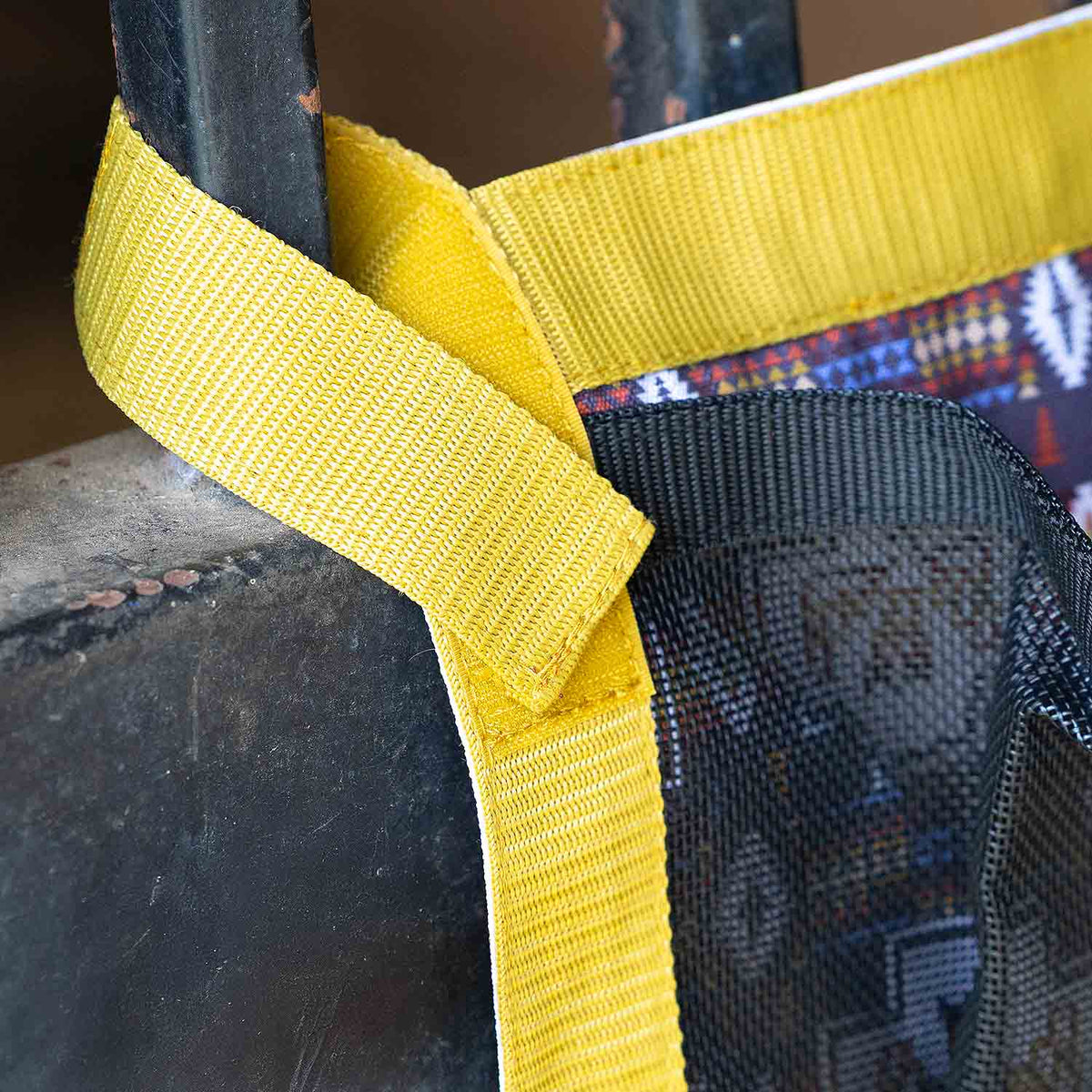 Jeffers Expression Trailer Door Horse Grooming Caddy with yellow strap over a patterned bag.