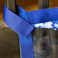 Load image into Gallery viewer, Jeffers Expression Trailer Door Horse Grooming Caddy in blue nylon webbing with a black mesh pocket.
