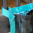 Load image into Gallery viewer, Jeffers Expression Trailer Door Horse Grooming Caddy with teal strap and black mesh pockets
