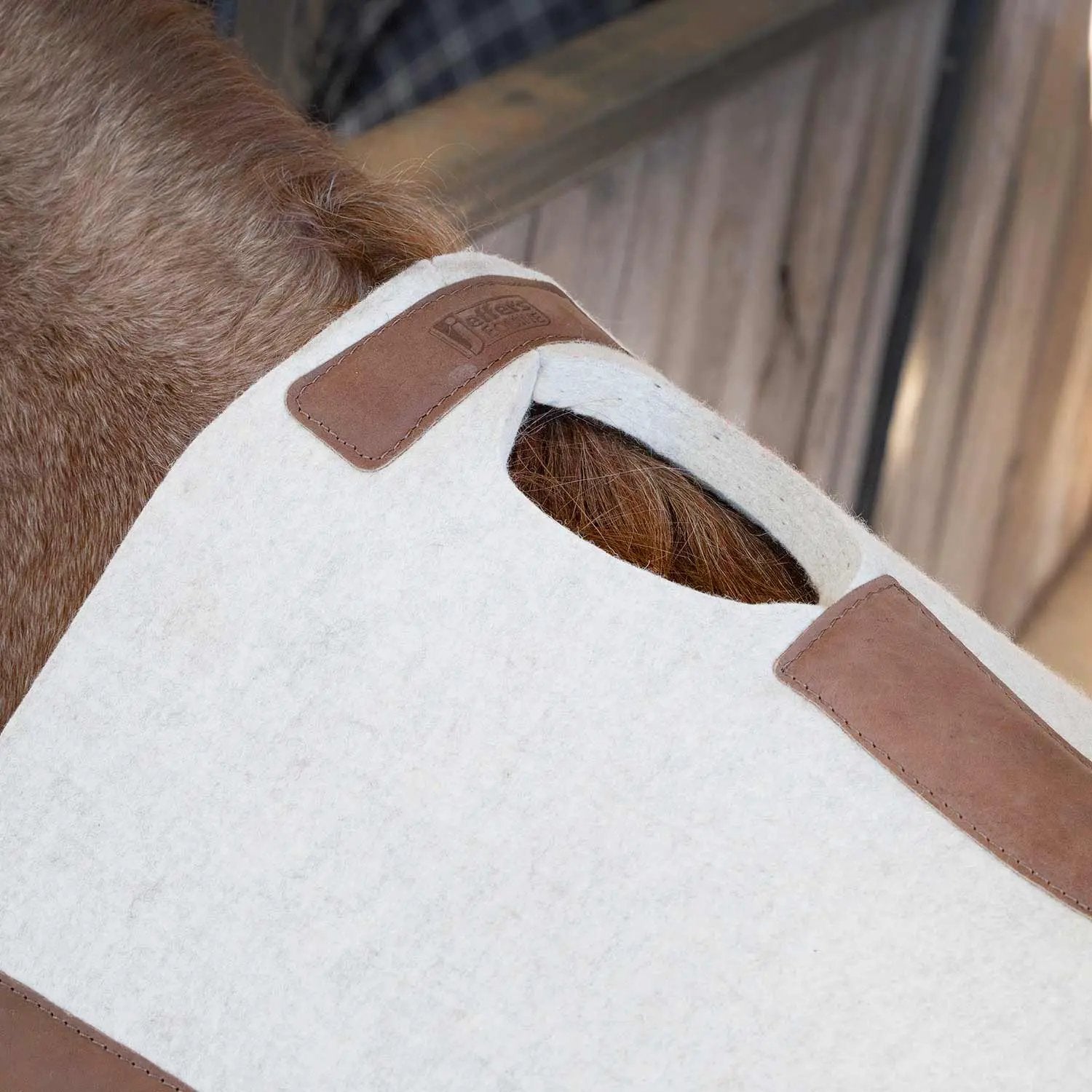 Jeffers WoolLuxe saddle pad, 100% wool, white with brown leather corner patches.