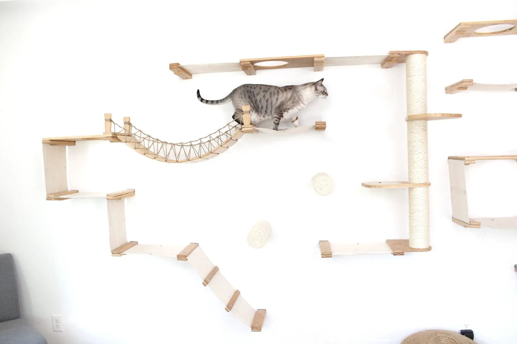 The Juggernaut indoor cat condo wall-mounted by Catastrophic Creations; wooden platforms, rope bridge, and sisal post.
