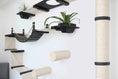 Gallery viewerに画像を読み込む, The Juggernaut cat condo on wall by Catastrophic Creations, black platforms with beige elements and a tall sisal post.

