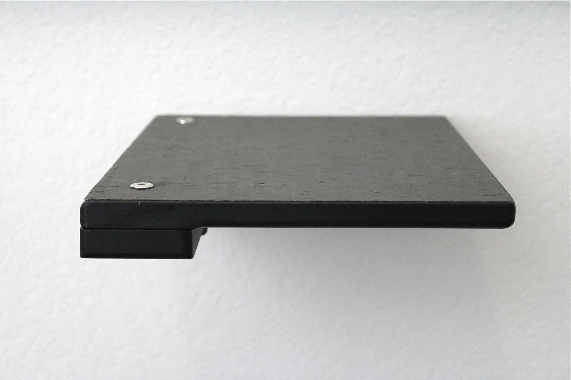 Cat climbing shelf platform in black wood with visible screws on top