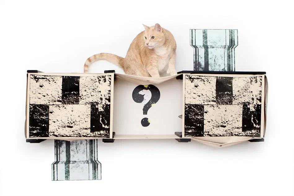 Super Mario Cat Tree cat condo with two cubbies and white center panel with a question mark; orange tabby on top.