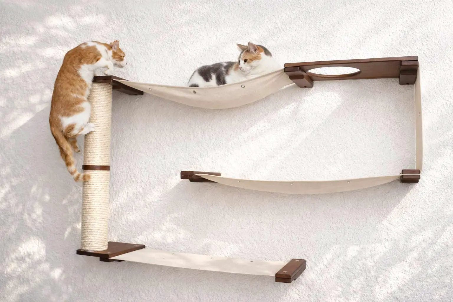 Cat Maze Wall - 3 Tier Cat Tree, beige fabric hammocks with sisal post, brown wood frame, two cats.