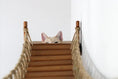 Load image into Gallery viewer, The Expedition cat condo by Catastrophic Creations on a wooden rope-railed wall system; cat peeking over steps.

