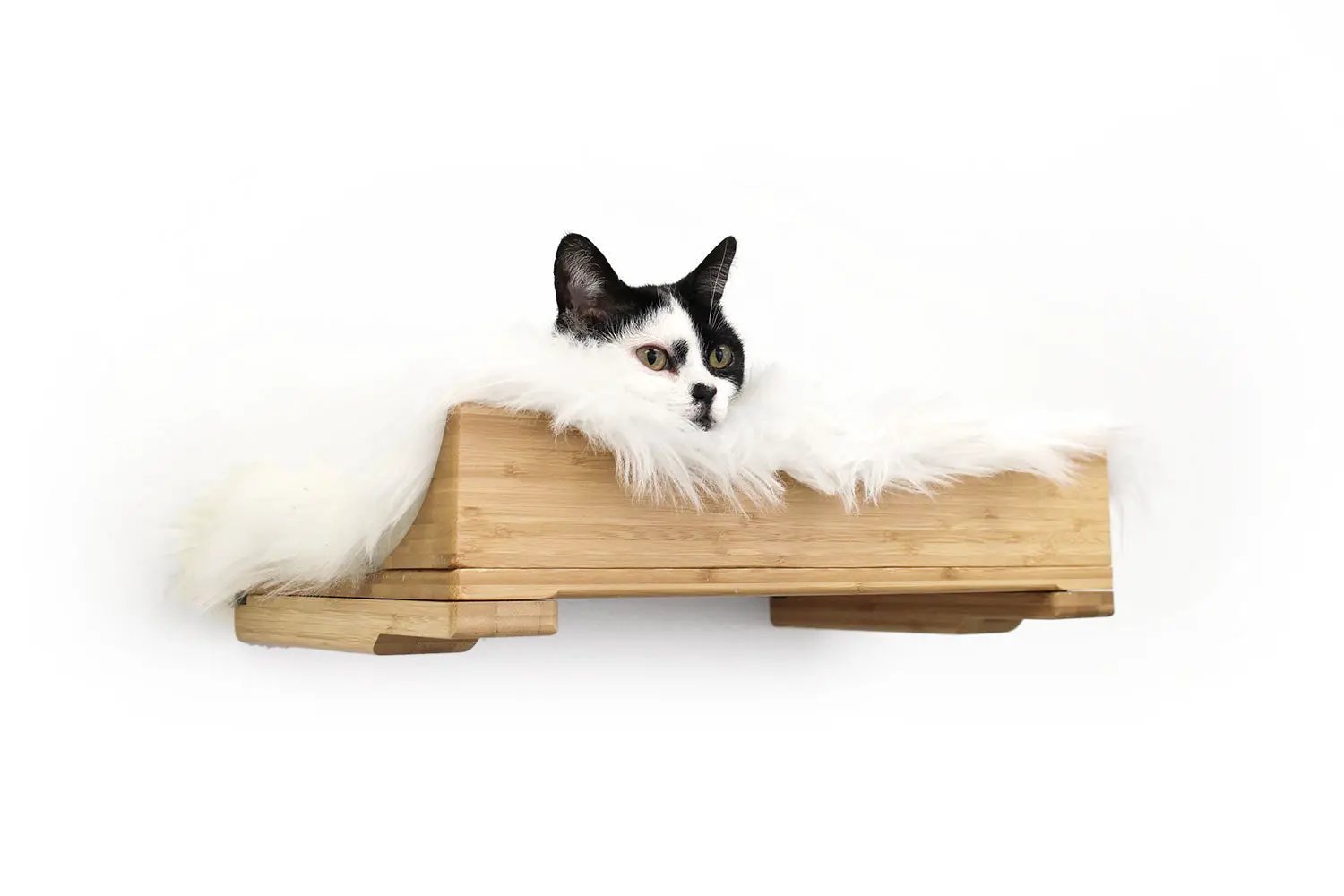 The Cat Nest Bed by Catastrophic Creations, wooden cat shelf bed with white fur trim and a black-and-white cat