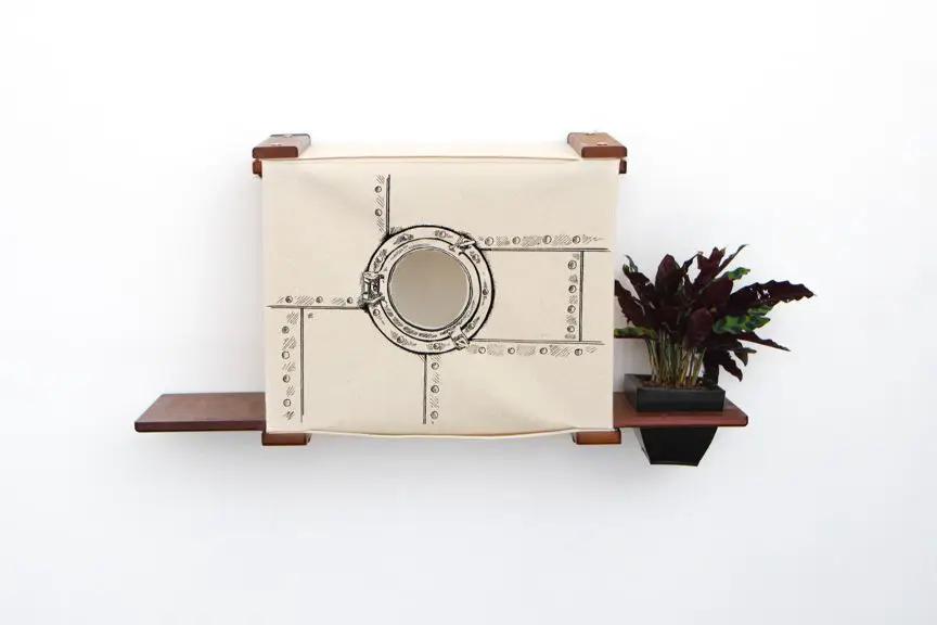 Deluxe Cat Cubby Bed by Catastrophic Creations, beige fabric cat condo with round porthole on wooden shelves.
