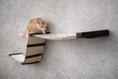 Carica l'immagine nel visualizzatore della galleria, The Raceway - Wall Mounted Cat Hammock with beige fabric and black supports; orange cat perched on the curved hammock.
