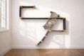 Carica l'immagine nel visualizzatore della galleria, The Play Cat Play Wall System cat condo with black panels and natural wood connectors mounted on a wall
