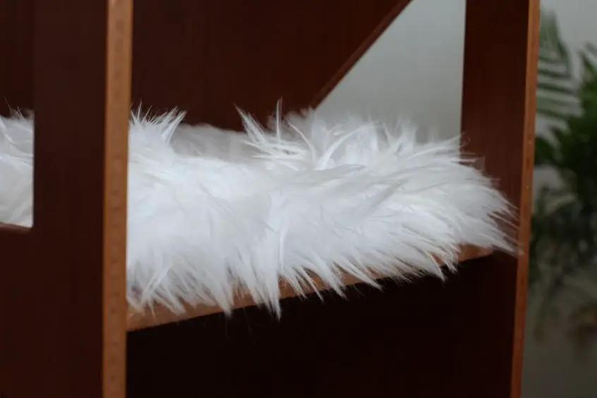 The Overlook cat condo with white fluffy cushion on bamboo frame