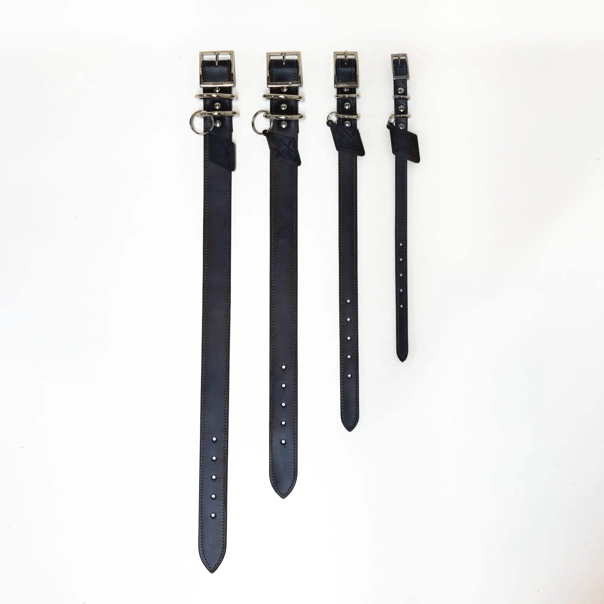 4 black leather dog collars by For Animals, With Love with metal buckles.
