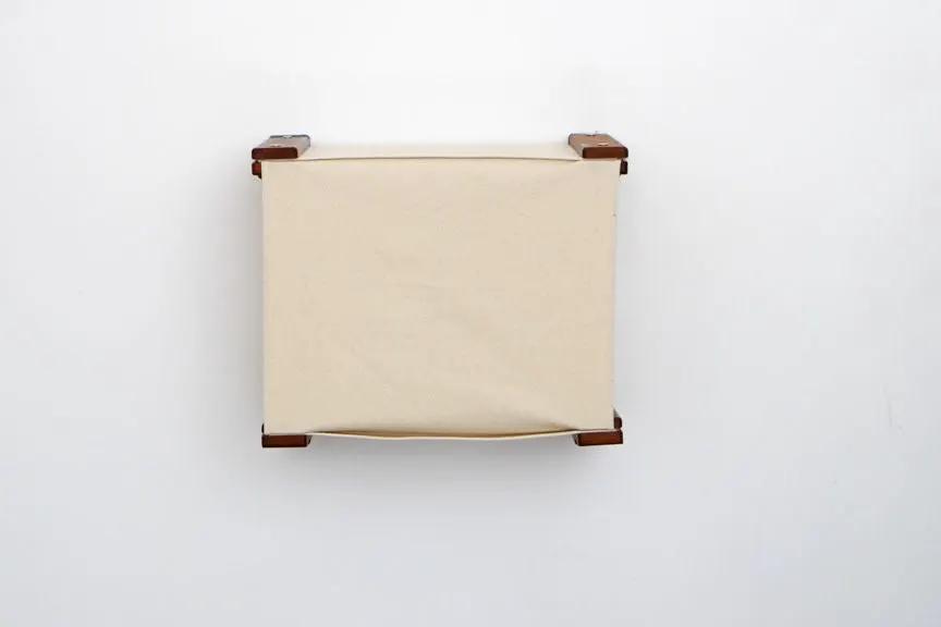 Enclosed cat bed wall cubby by Catastrophic Creations, beige fabric cover with wooden frame.