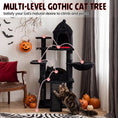 Load image into Gallery viewer, 50-Inch Gothic Multi-Level Cat Tree with Castle House in black plush, cat on lower level amid pumpkins
