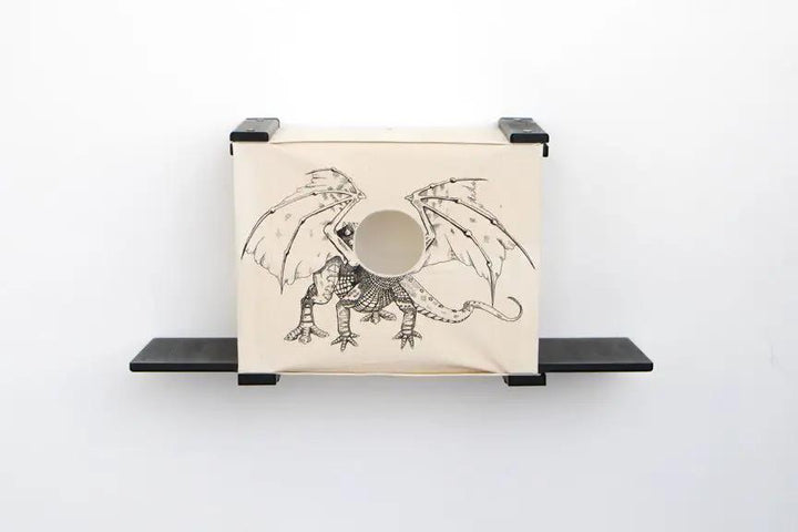 Cat Cubby for Wall - Covered Cat Bed; beige fabric cubby with dragon print and circular opening, wall-mounted.