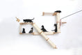 Load image into Gallery viewer, The Crossroads cat condo wall scratcher tree with ramp; natural wood and sisal rope, several black cats climbing.
